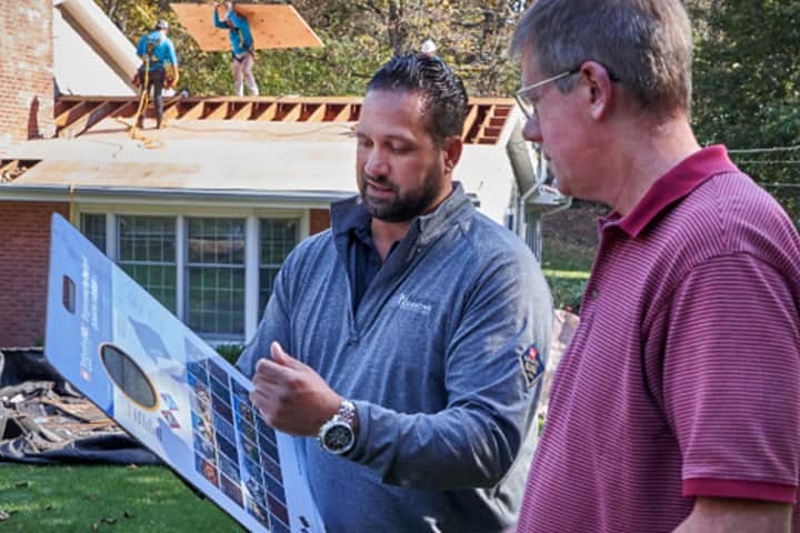 GAF contractor showing shingle color palette to homeowners.