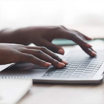 Hands typing on keyboard.