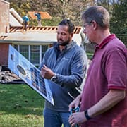 GAF contractor outside home showing homeowner roofing shingles options.