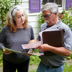 Two people discussing options with documents in hand