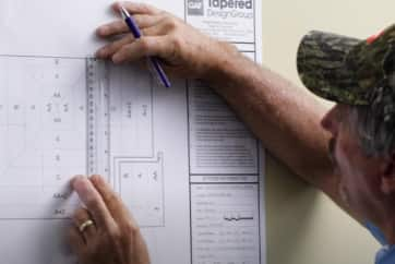 roofer measuring tapered roof design blueprint