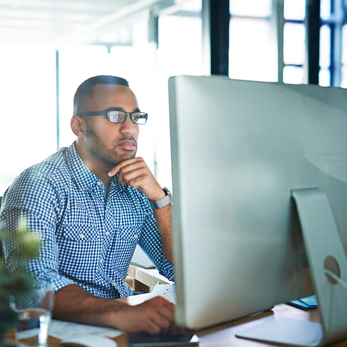 man in office space using a desktop computer