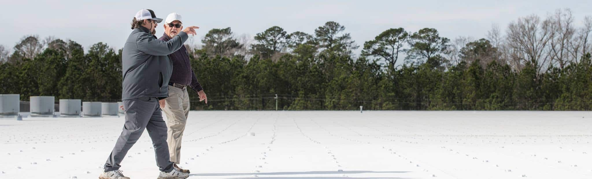 two contractors on a commercial roof