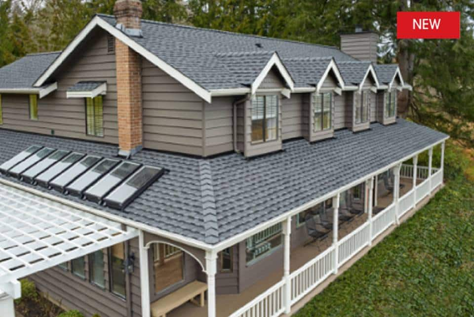 Beige home with a gray roof featuring new GAF Timberline UHDZ shingles.