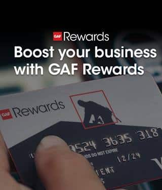 Hand holding GAF Rewards gift card for contractor rewards program