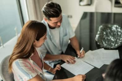 Man and women reviewing paperwork on a table.