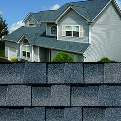 GAF Timberline HDZ biscayne blue shingle closeup with sample product image on a gray house.