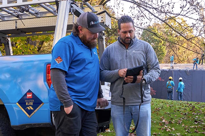 contractor and roofer discussing a roofing job